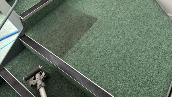 Clean patch on green carpeted stairs